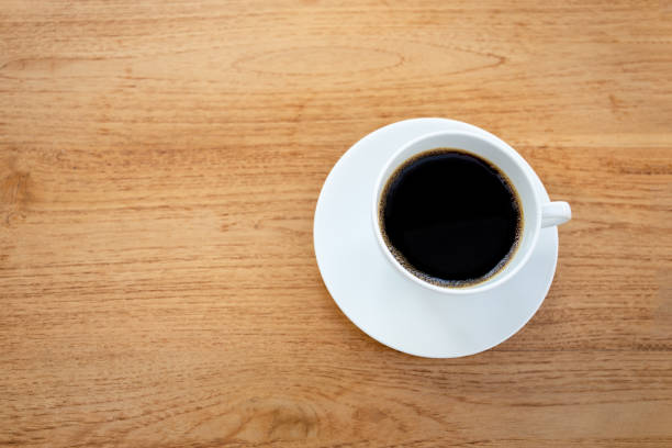 istock Top view cup of coffee on wooden table. 1215633141