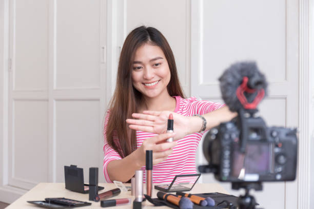 istock Beauty blogger of Asian female tutorial makeup cosmetics live broadcasts video streaming. Vlogger are smiling while reviewing products 1215635842