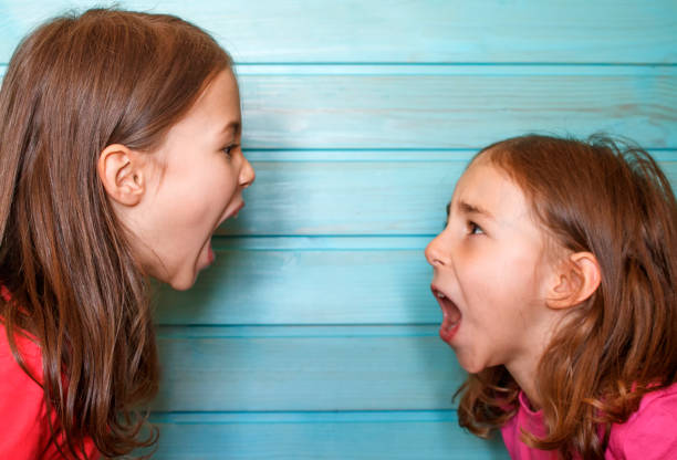 istock A quarrel between friends. Girls scream at each other 1215635979
