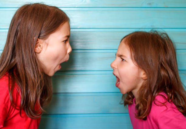 istock A quarrel between friends. Girls scream at each other 1215635986