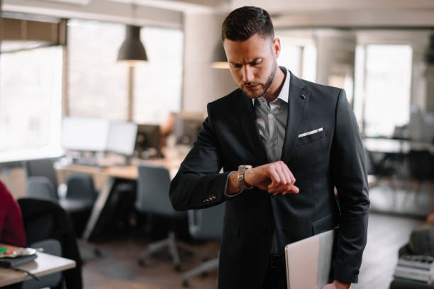 istock Businessman looking at wristwatch. 1215639464