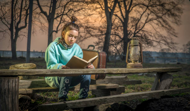 istock A girl reads a book in the evening 1215641705