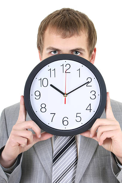 istock young businessman holding a clock 121564683
