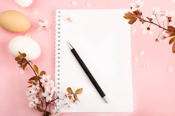 istock Easter composition white and brown eggs lie on a pink background with sakura flower petals 1215647714
