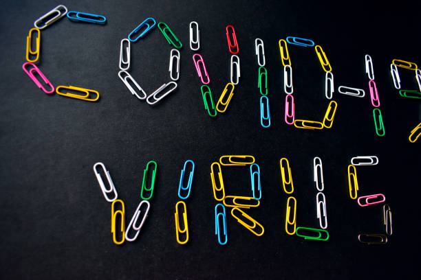 istock Covid-19 virus with colored paper clips on a black background 1215649996