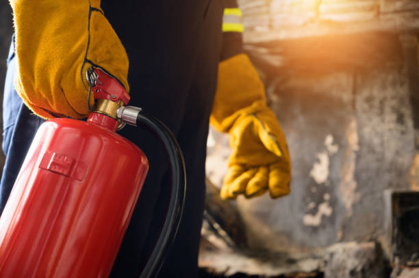 istock Close up hand Fireman,Firefighter holding the fire extinguisher. 1215651374