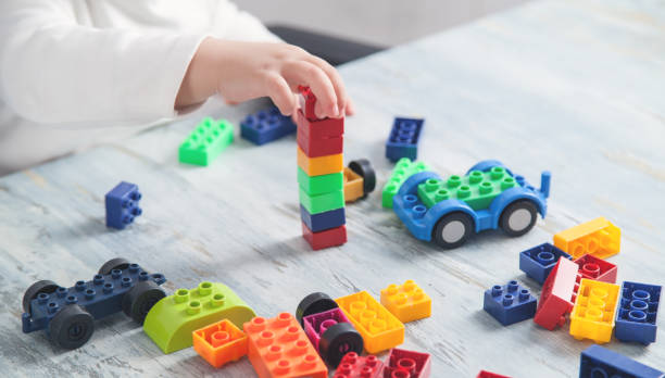 istock Little girl playing with colorful construction plastic blocks. 1215651547