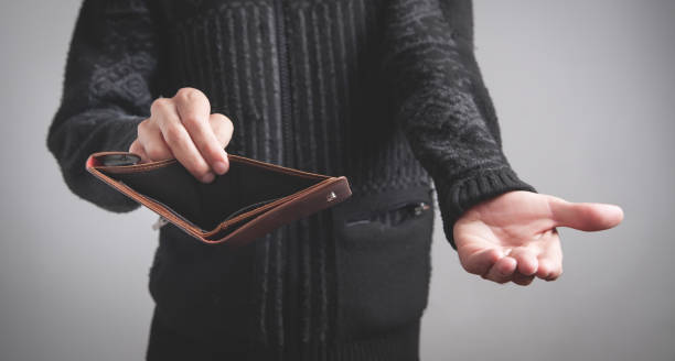 istock Man holding empty wallet. No money 1215651562