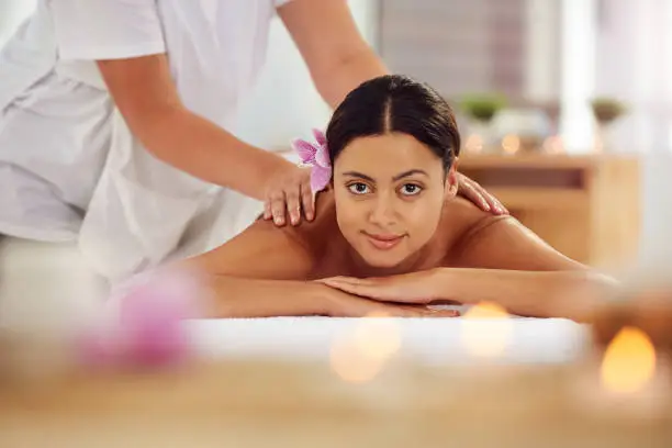 Cropped portrait of an attractive young woman lying on a massage table in a beauty spa