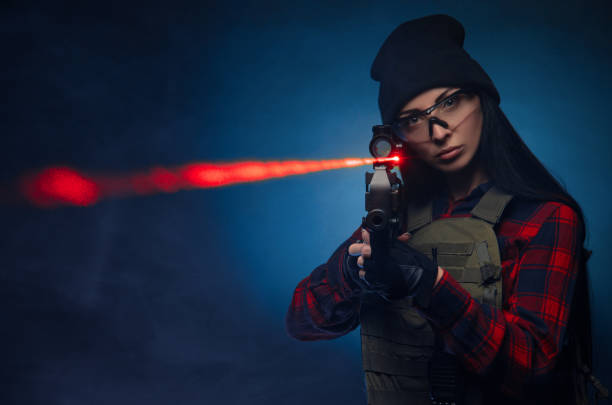 istock a girl in a checked shirt on a dark background with an automatic rifle 1215655834