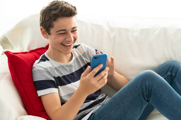 istock Happy teenage boy using video call on mobile phone 1215655916
