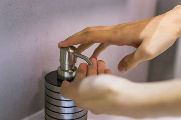istock hands with soap dispenser, personal hygiene 1215657314