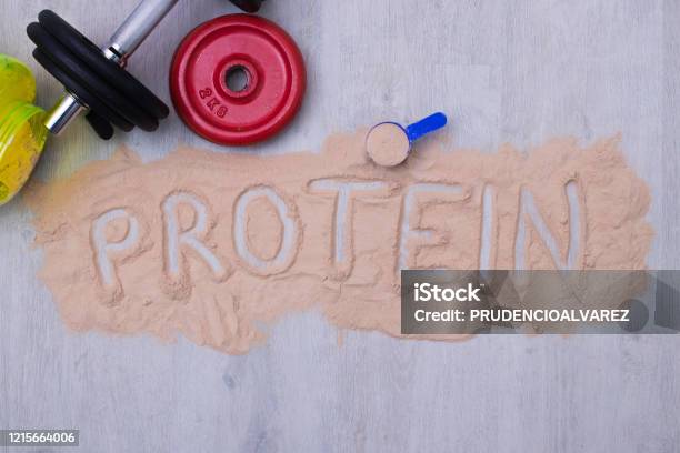Protein Powder And Dumbbells Or Gym Weights Stock Photo - Download Image Now - Protein, Ground - Culinary, Sport