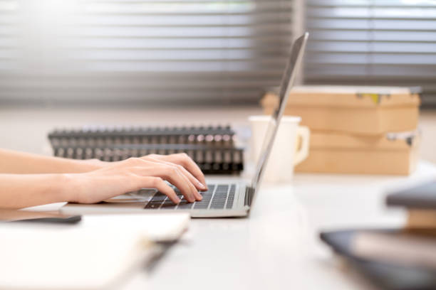 close up business female hand type use laptop communication working at office window background