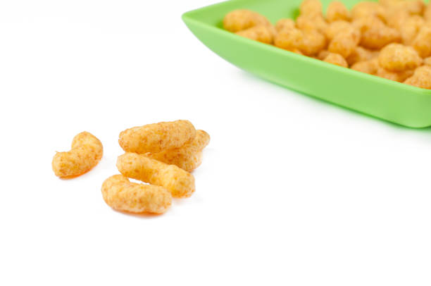 Salty snacks in green plate isolated on white background.Copy space