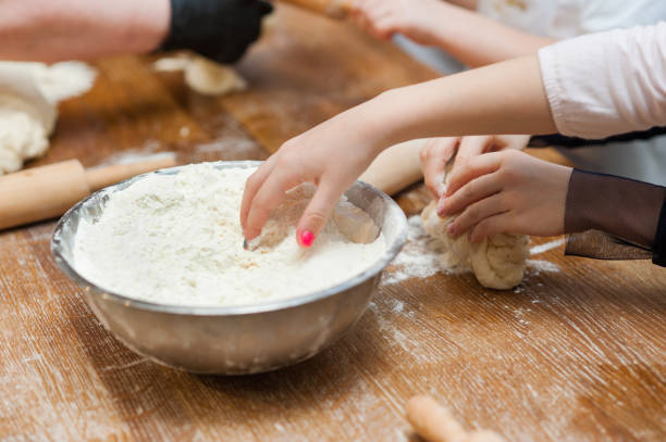 istock children's hands take flour from the bowl. 1215668805