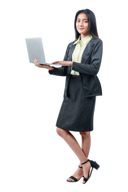 istock Asian businesswoman standing while using laptop 1215668894
