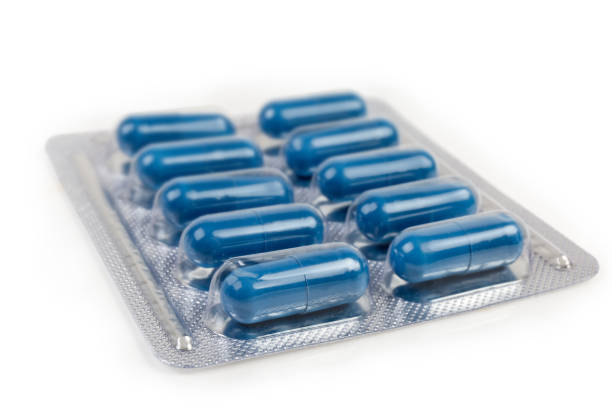 istock Blister pack with blue pills, close-up in selective focus 1215669004