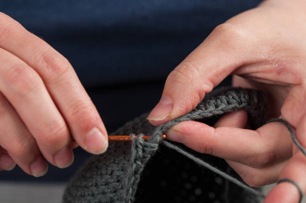 istock Woman hands knitting crochet.Crochet hook. 1215669306