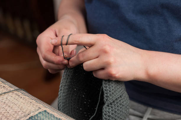 istock Woman hands knitting crochet.Crochet hook. 1215669382