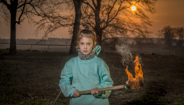 istock A girl with a burning torch. 1215669466