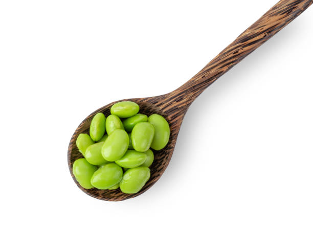 istock soy beans in wood spoon isolated on white background. top view 1215670563