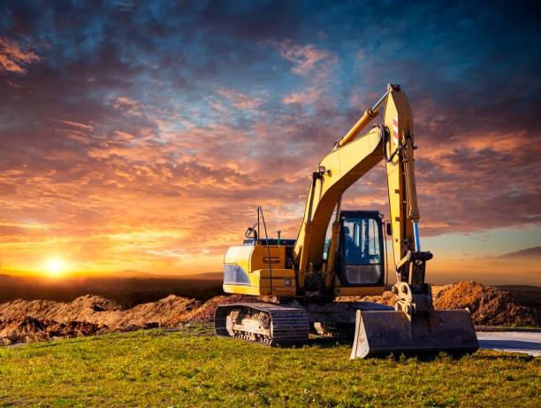 istock Excavator at a construction site against the setting sun 1215671358