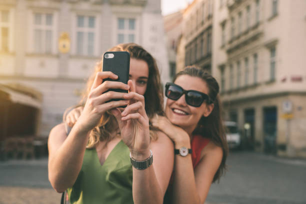 istock Girlfriends taking selfies in the city streets 1215673108