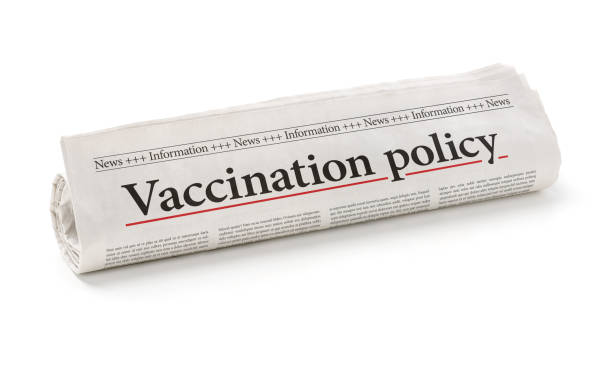 istock Rolled newspaper with the headline Vaccination policy 1215675362