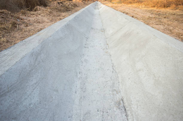 istock Concrete drainage trays for a drain. Drainage in the city. Sewerage construction. 1215675470