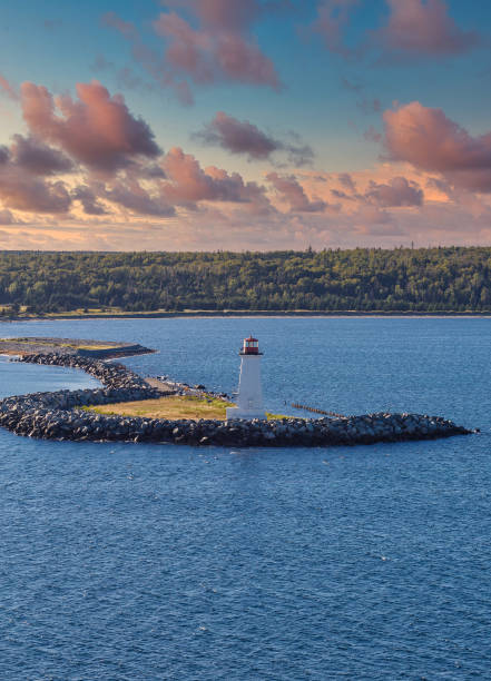istock Lighthouse on Sea Wall at Dusk 1215676747