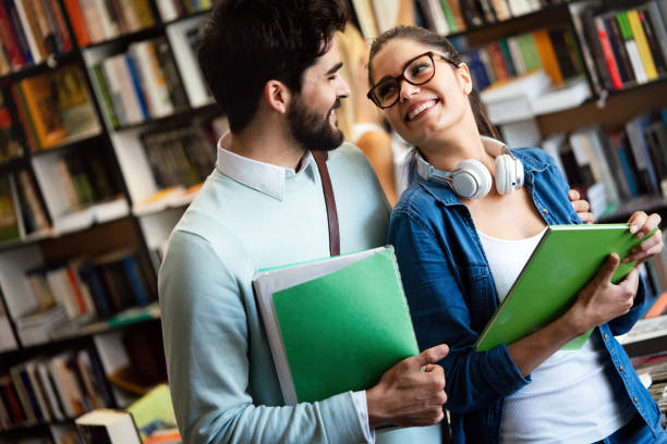 istock Group of college students studying in the school library 1215676848