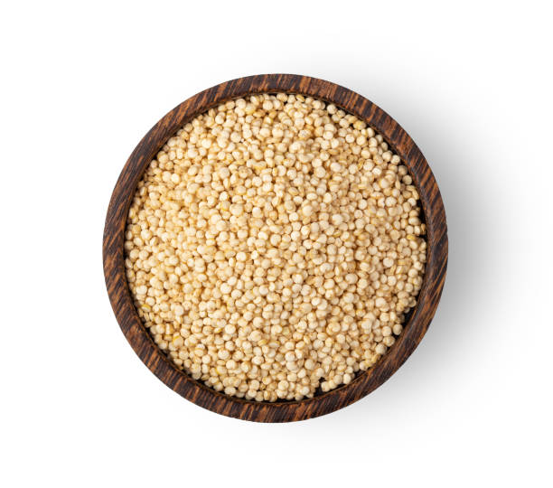 istock quinoa seeds in wood bowl isolated on white background. top view 1215676875