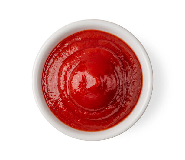 istock tomato sauce in a bowl isolated on white background. top view 1215676909