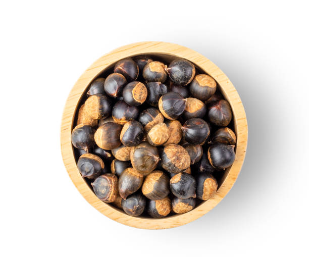 istock thai chestnuts in wood bowl  isolated on white background. top view 1215676927
