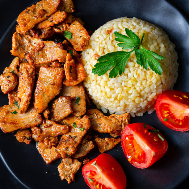 istock bulgur with fried meat and yoghurt sauce 1215677061