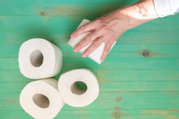 istock Hand outstretched to take toilet paper roll 1215678209