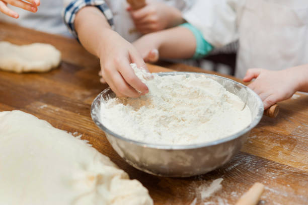 istock children's hands take flour from the bowl. 1215678293
