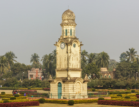 Murshidabad, West Bengal/India - January 15 2018: The Murshidabad Clock Tower aka Ghari Ghar in the gardens of the Nizamat Imambara.