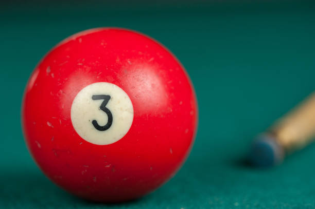 istock Billiards balls and cue on billiards table. Billiard sport concept 1215679787