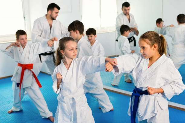 istock Teenagers practicing new karate moves in pairs in class 1215679861