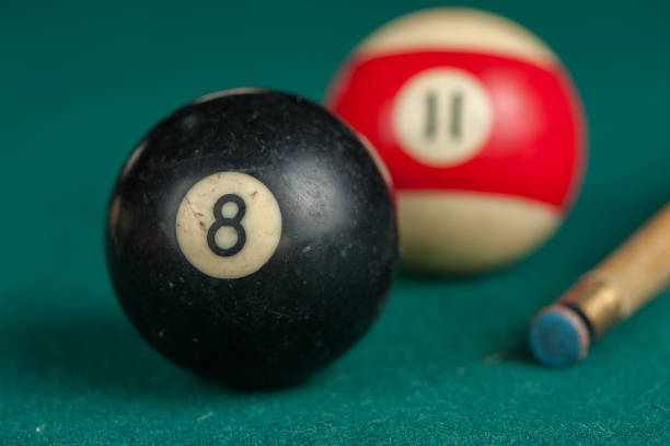 istock Billiards balls and cue on billiards table. Billiard sport concept 1215679992
