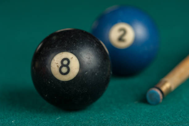 istock Billiards balls and cue on billiards table. Billiard sport concept 1215680138