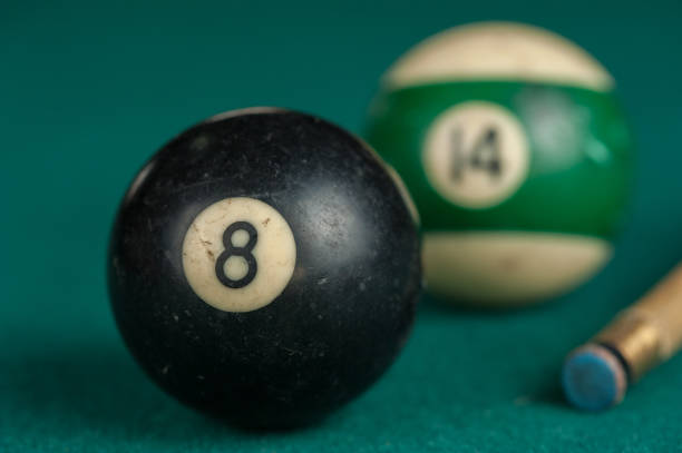 istock Billiards balls and cue on billiards table. Billiard sport concept 1215680210