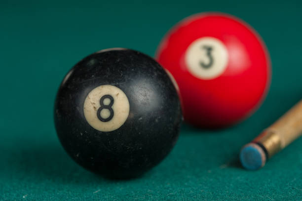 istock Billiards balls and cue on billiards table. Billiard sport concept 1215680281