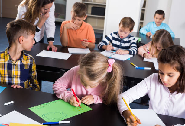 istock Professor and elementary age happy children 1215680750