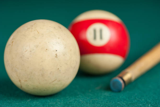 istock Billiards balls and cue on billiards table. Billiard sport concept 1215683640