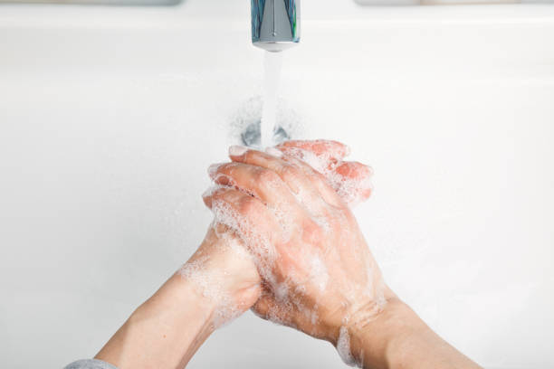 istock Person washing hands protective measures against coronavirus germ and bacteria spreading 1215683853