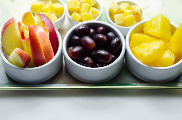 istock Various set fruits, pineapple, apple, grapes with matured cheddar cheese in bowls 1215685811