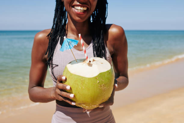 istock Woman enjoying refreshing coconut cocktail 1215685918